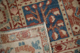 Folded corner of a Baktiari rug contrasting the blue and red pile with its hand-knotted back.