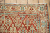 Corner detail of a vintage Joshegan rug with a reciprocating pawn design border.