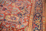 Detailed view of the hand-knotted texture and Turtle Samovar border of a vintage Heriz carpet.
