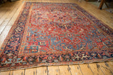 Full-length perspective of a vintage Heriz carpet with bold geometric motifs in ruby and sapphire.