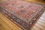Vintage Heriz carpet's navy border with Turtle Samovar design motif and brick red field.
