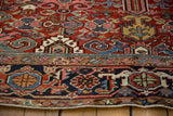 Vintage Heriz rug's navy main border with Turtle Samovar motifs, showing side cord selvage.
