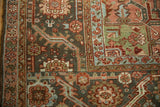 Close-up on the corner spandrel of a vintage Heriz carpet with lime green and powder blue motifs.