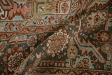 Detailed texture of a distressed Heriz carpet showing powder blue and lime green floral motifs.
