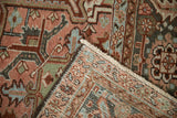 Flipped corner of a vintage Heriz rug showing the hand-knotted foundation and intact selvage.