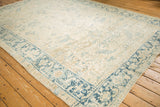 Angled view of a distressed Heriz carpet corner highlighting the dusty blue Turtle Samovar border design.