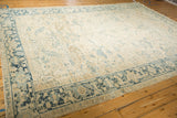 Angled view of a distressed Heriz carpet highlights the dusty blue Turtle Samovar border design.