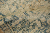 Textured close-up of a vintage Heriz showing mostly even wear across the knot heads.