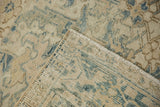 Corner detail of the vintage Heriz carpet showing its hand-knotted foundation and secured side cord.