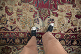 Antique Kerman carpet, fine hand-knotted texture, cochineal, ivory, blue curvilinear motifs.