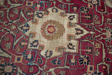 Antique Kerman carpet's ivory field transitions to cochineal floral blossoms and navy blue vines.