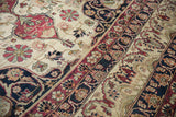 Antique Kerman carpet with cochineal floral vines on ivory, navy palmette border, circa 1890s.