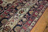 Antique Kerman rug border with meandering palmette and arabesque design in cochineal, navy, ivory.