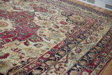 Navy palmette and arabesque border of antique Kerman with cochineal and ivory florals.
