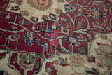 Antique Kerman carpet detail: dynamically drawn floral arabesques in cochineal, ivory, and blues.