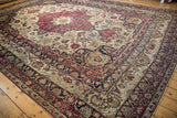 Antique Kerman carpet corner, hand-knotted palmette arabesque border in cochineal, navy, ivory.