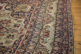 Antique Persian Kerman rug border, with meandering palmettes and arabesques in cochineal, ivory, navy.