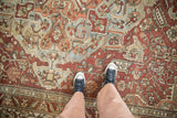 Vintage Distressed Baktiari carpet, softened pile with dusty red, blue, green floral patterns.