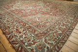 Vintage distressed Baktiari carpet corner; intricate spandrel, borders, dusty red, blue, ivory hues.