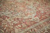 Distressed vintage Baktiari carpet with worn dusty red, blue floral patterns.
