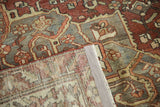 Vintage distressed Baktiari carpet with worn pile texture, hand-knotted foundation, and side selvage.