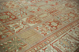 Vintage distressed Baktiari carpet detail, showing repeating garden-paradise panels in soft red, blue, green.