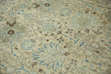 Distressed vintage Tabriz carpet, Safavid palmette motifs in dusty sapphire blue, brown, and cream.