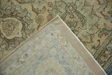 Distressed Tabriz rug corner showing Safavid palmette motif, pile wear, side cord, and woven foundation.