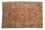 Distressed vintage Heriz carpet with concentric medallion, ruby red, slate blue, and ivory Herati designs.
