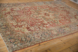 Distressed vintage Heriz rug corner, highlighting slate blue border and turtle samovar motifs.