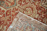 Distressed vintage Heriz rug's hand-knotted foundation, showing ruby red pile and selvage.