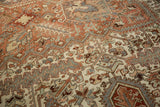 Softened pile and serrated leaf patterns of the distressed Mehrivan carpet in copper, slate blue, and sand.