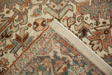 Vintage distressed Mehrivan carpet corner, showing worn pile, serrated leaf motifs, and hand-knotted foundation.