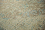 Distressed Vintage Tabriz carpet showing faded blue arabesque details and textured pile.
