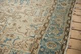Vintage distressed Heriz rug, showing worn beige field, dusty blue border with Herati motif.