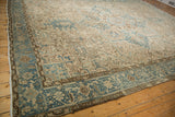 Distressed Heriz rug corner, dusty blue Herati border, and subtle field patterns.