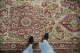 Close-up showing the mostly even wear and low-pile texture of a distressed Kerman carpet.