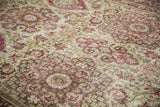 Angled detail of the distressed Kerman carpet's low pile and floral bouquet medallions.