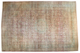 Vintage distressed Meshed carpet with a floral medallion in faded raspberry red, powder blue, and beige.