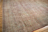 Heavy abrash and time-softened wear on a vintage Persian carpet with an allover floral design.