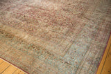 A corner view showing the heavy abrash and dye lot variation in a vintage distressed Meshed carpet.