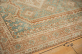 Distressed vintage Afshar rug detail, showing geometric patterns, dusty blue, and worn pile.