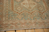 Vintage distressed Afshar rug's geometric border, dusty blue, ivory, terra cotta patterns, and wear.