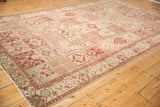 Angled view displaying the repeating panel design and low pile of a distressed Baktiari rug.