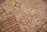 Angled view of the worn, hand-knotted pile on a Bakhtiari rug with repeating garden panels.