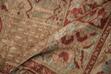 Close-up showing the even wear and low pile texture of a vintage Baktiari carpet in muted red and sand.