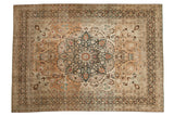 A distressed Persian Meshed carpet with a roundel medallion, palmette border, and heavy, charming color abrashes.