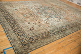 Worn texture on a vintage Meshed carpet with a charcoal palmette border and sandalwood field.