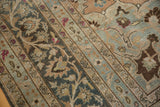 Meandering vine and palmette border of a vintage Persian carpet with a distressed, low pile.