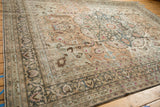 Full angled view of a distressed Persian Meshed carpet with intricate floral borders and medallion.